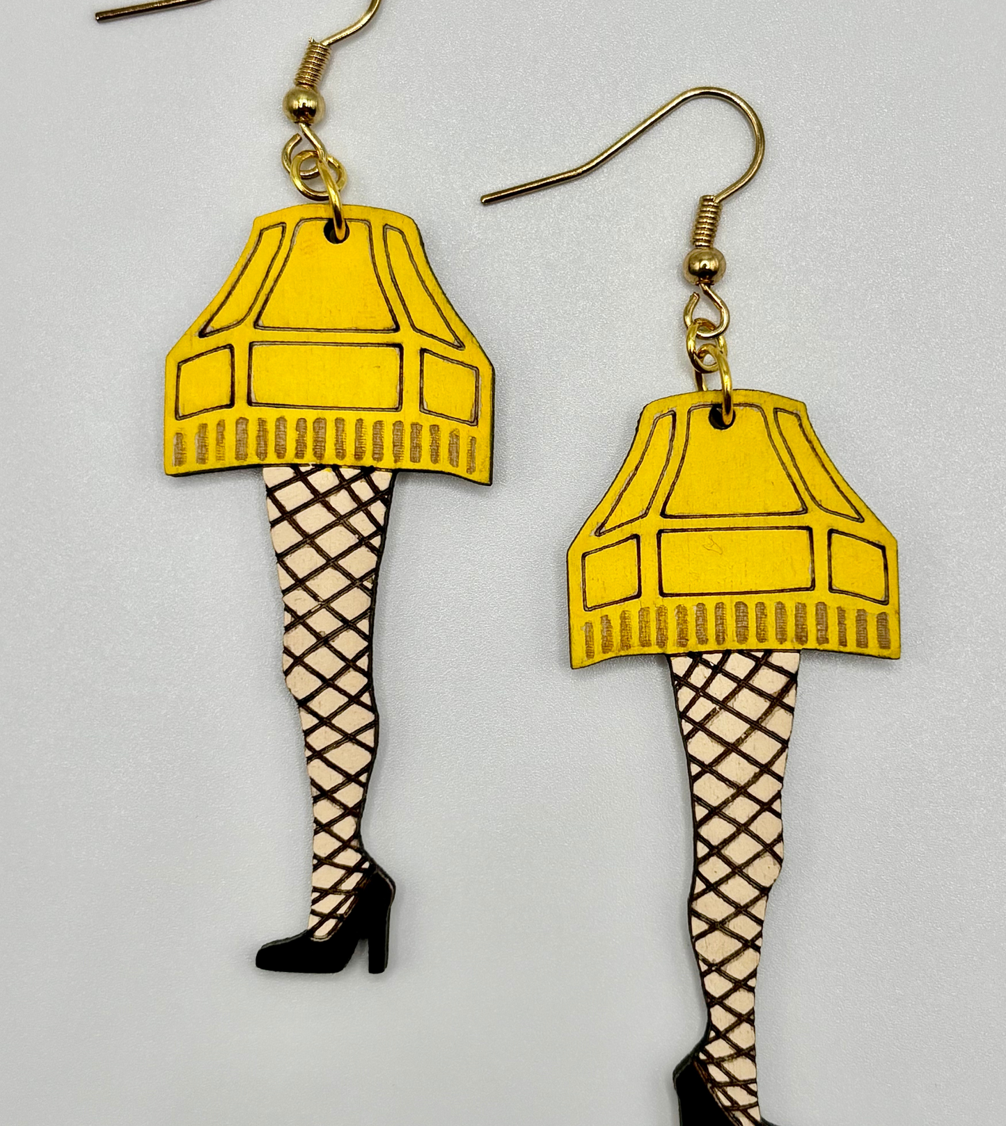 Fragile Leg Lamp Earrings. Adorable Christmas themed earrings featuring hypoallergenic hooks for sensitive ears.